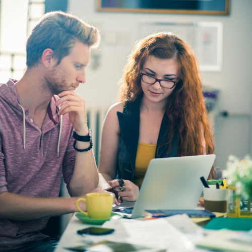 Two people sitting at a laptop