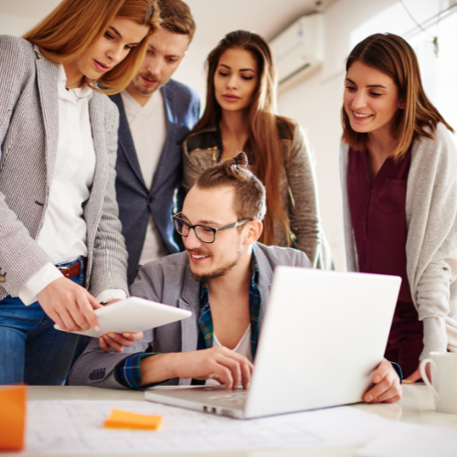 People crowding around a laptop
